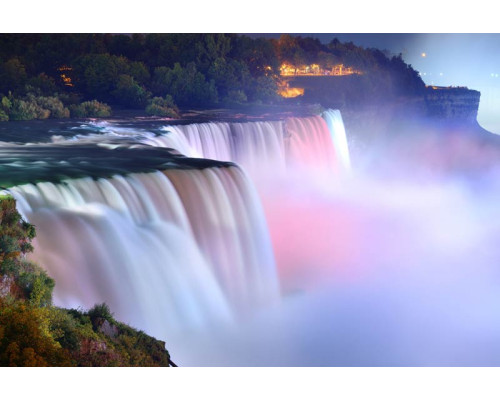 Fotobehang van de Niagarawatervallen, waar het water met kracht naar beneden stort en het omliggende landschap domineert.