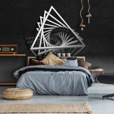 Fotobehang in een kinderkamer met speelse driehoeken in 3D-stijl op een donkere achtergrond die diepte toevoegt.