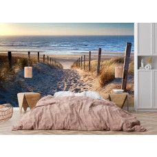 Fotobehang met een duinpad naar zee in een slaapkamer voor een rustige en ontspannen sfeer.