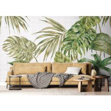Een fotobehang met grote groene bladeren in de woonkamer, waar het botanische design een frisse en rustgevende sfeer creëert.