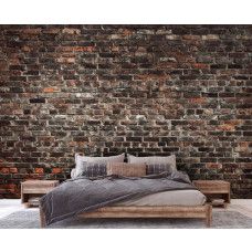Een fotobehang van een industriėle stenen muur met urban stijl in een slaapkamer.