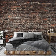Een fotobehang van een industriėle stenen muur met urban stijl in vliesbehang voor een slaapkamer.