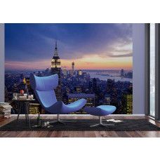 Fotobehang met een zonsondergang boven de skyline van New York in een woonkamer.