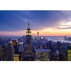Fotobehang met een zonsondergang boven de skyline van New York.