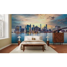 Fotobehang panorama New York bij zonsondergang in slaapkamer met brug en wolkenkrabbers aan het water.