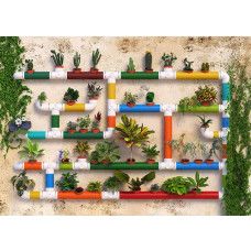 Een fotobehang van tuinplanten op een waterleidingmuur.