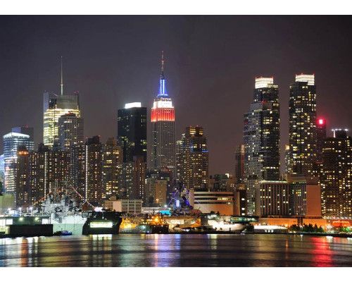 Fotobehang van de skyline van New York in de Nacht en zijn verlichte wolkenkrabbers.
