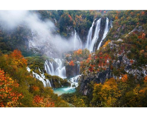 Fotobehang van de Plitvicemeren in Kroatië, waar watervallen door een weelderig nationaal park stromen.