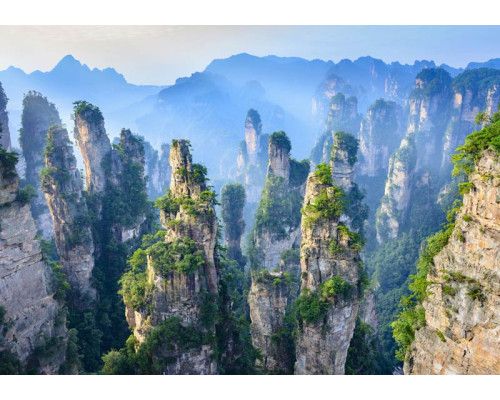 Fotobehang van het Zhangjiajie National Forest Park in China, met indrukwekkende gebergten en bergen omringd door weelderige natuur.