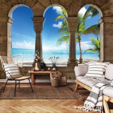 Een 3D-fotobehang met uitzicht op een strand, zee en palmbomen, zichtbaar in een woonkamer.