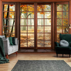 Een fotobehang met een kleurrijk herfstbos bedrukt op vliesbehang, passend in een woonkamer.