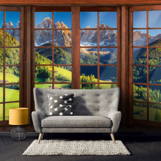 Een fotobehang met 3D-raamzicht op de Alpen in een gezellige huiskamer.