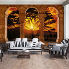 Een fotobehang met een Afrikaans landschap met pilaren, geschikt voor een huiskamer.