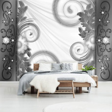 Een fotobehang met artistieke abstracte vormen en bloemen in een slaapkamer.