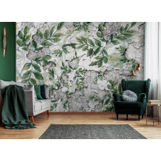 Een fotobehang met bladeren op een betonnen muur en planten te zien in de huiskamer.