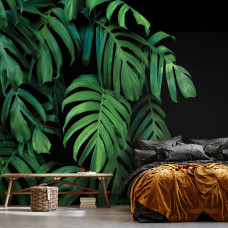 Een fotobehang met tropische bladeren in een botanisch ontwerp op een donkere achtergrond, ideaal voor een woonkamer.