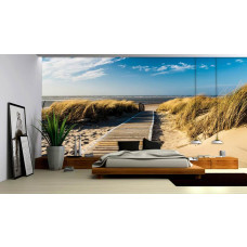 Een fotobehang van duinen en strand met een uitzicht op zee, geschikt voor een slaapkamer.