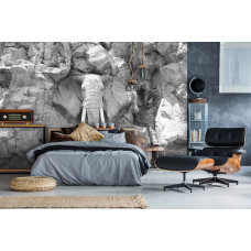 Een fotobehang van een olifant ingekerfd in grijze rotsen, geschikt voor een kinderkamer.