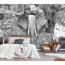 Een fotobehang van een olifant sculptuur in rotsen, ideaal voor een rustige slaapkamer.
