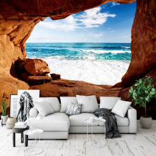 Een fotobehang van een grot met uitzicht op zee in 3D-effect voor de woonkamer.