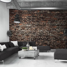 Een fotobehang van een industriėle stenen muur met urban stijl in een woonkamer.