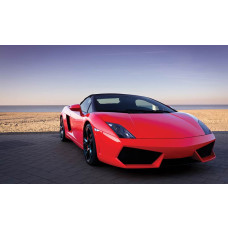 Fotobehang van een rode Lamborghini aan zee, sportauto in een exotisch landschap.