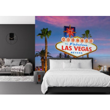 Fotobehang met Las Vegas-welkomstbord tegen een roze en paarse avondlucht in de slaapkamer.