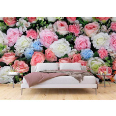 Slaapkamer met fotobehang van grote roze, witte en lichtblauwe rozen achter een bed.