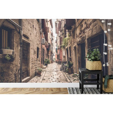 Een fotobehang met een Toscaanse steeg, afgebeeld in een slaapkamer.