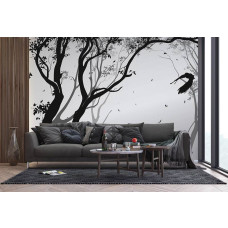 Een fotobehang van een silhouet van een bos met een vogel in de wind in een woonkamer met vliesbehang.