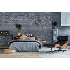 Een fotobehang met een antraciet stenen muur in een strak ontwerp, ideaal voor een slaapkamer.