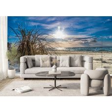 Fotobehang met helmgras op het strand en stralende zon boven zee in de woonkamer.