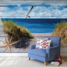 Een fotobehang van een natuurlijk strandlandschap met duinen en oceaan in een slaapkamer.