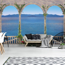 Een fotobehang met uitzicht op zee vanaf een Grieks balkon met zuilen.