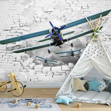 Een fotobehang met vliegtuigen door een bakstenen muur met 3D-effecten voor de babykamer.