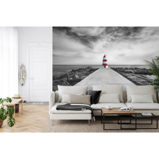 Een fotobehang met een rustgevend strandlandschap met een vuurtoren, geschikt voor een huiskamer.