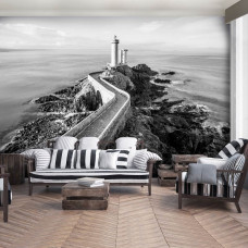 Een fotobehang van een vuurtoren aan de zee met een landschap voor de woonkamer.