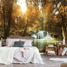 Een fotobehang met een waterval in een herfstbos met bomen en een boom in de slaapkamer.