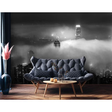 Een fotobehang van wolkenkrabbers in de nacht in New York, met wolken in de huiskamer.