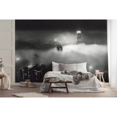 Een fotobehang van wolkenkrabbers in de nacht in New York, met wolken voor de slaapkamer.