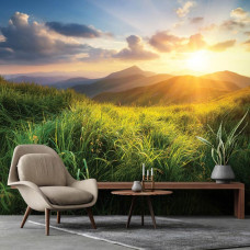 Een fotobehang van een uitgestrekt berglandschap met een zonsondergang in de verte, gezien vanuit een gezellige woonkamer.
