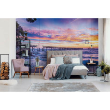 Een fotobehang met een betoverende zonsondergang boven de zee, ideaal voor een slaapkamer.