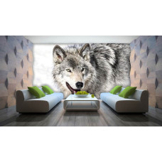 Een fotobehang met een wolf in een besneeuwde omgeving voor de woonkamer.