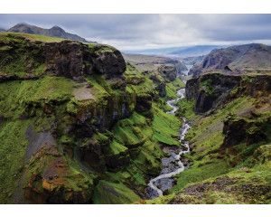 Fotobehang van een berglandschap met een beekje, natuur in rustgevende tinten.