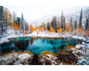 Fotobehang van een geisermeer in Siberië, Rusland, omgeven door bossen en bergen, met een mystieke uitstraling.