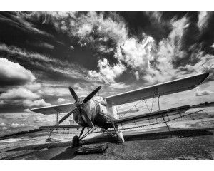 Fotobehang van een zwart-wit vliegtuig, minimalistisch design.