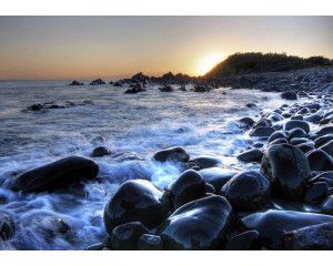 Fotobehang Zonsopgang bij Kiezelstrand